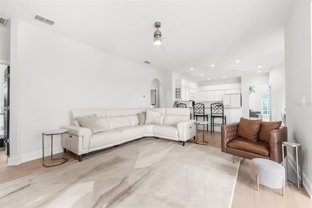 living room with ceiling fan and light hardwood / wood-style floors