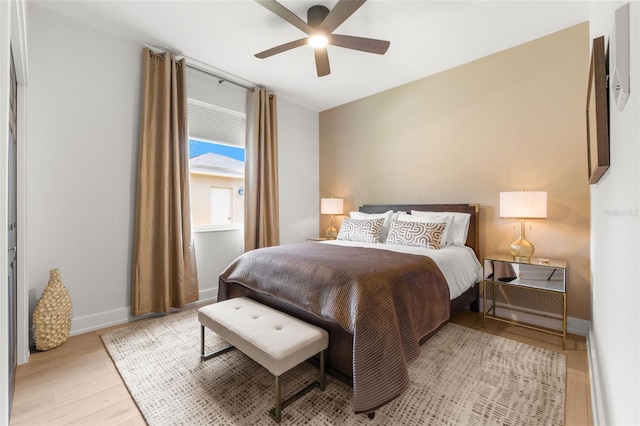 bedroom with ceiling fan and light hardwood / wood-style flooring