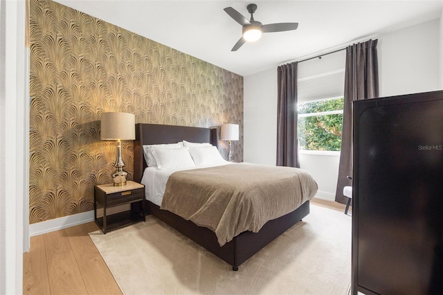 bedroom with light hardwood / wood-style flooring and ceiling fan