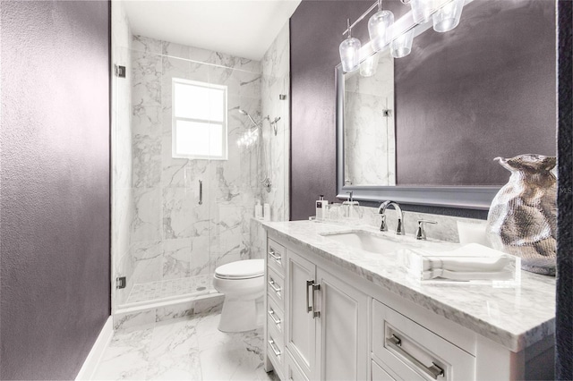 bathroom featuring vanity, a shower with shower door, and toilet