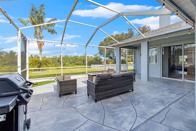 view of patio with glass enclosure and a grill