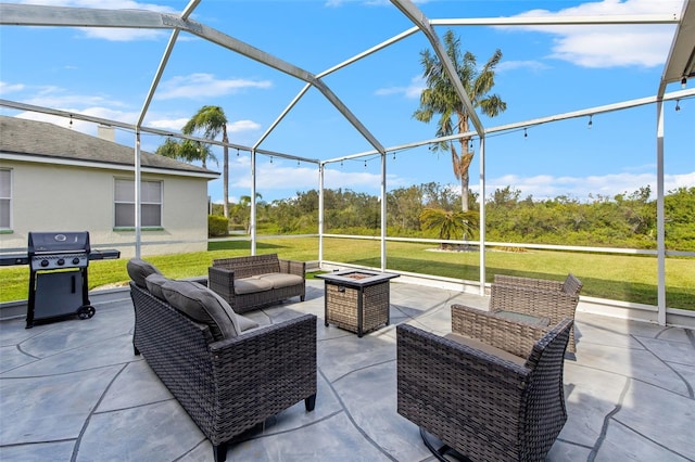 view of patio / terrace with glass enclosure, a grill, and an outdoor fire pit