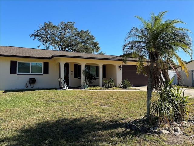 ranch-style home with a garage and a front lawn