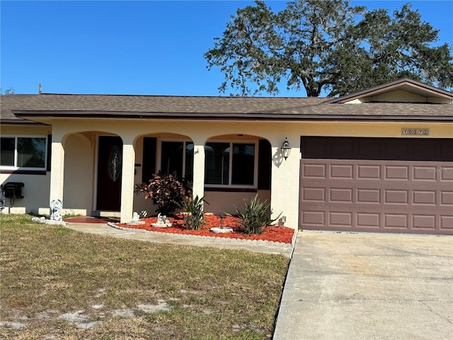 single story home featuring a garage and a front lawn