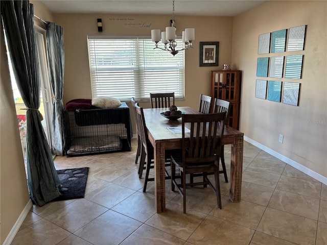 tiled dining area featuring a chandelier