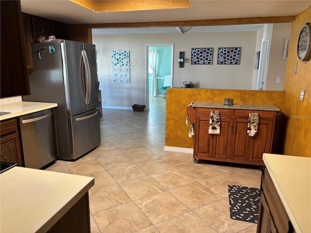 kitchen featuring light tile patterned floors and stainless steel appliances