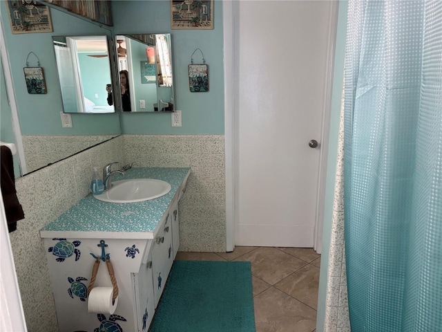 bathroom featuring vanity, tile patterned floors, and tile walls