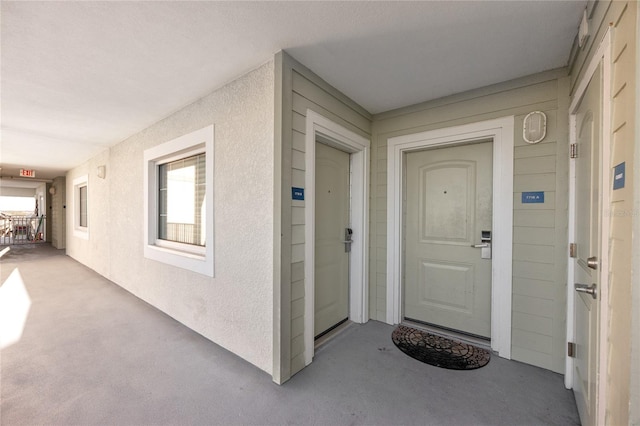 399 2nd St Unit 718, Indian Rocks Beach, FL 33785 - doorway to property with stucco siding