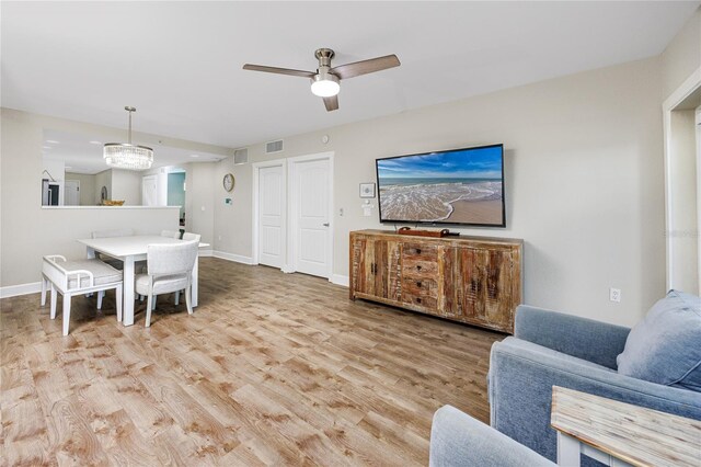 399 2nd St Unit 718, Indian Rocks Beach, FL 33785 - living area featuring wood finished floors, ceiling fan, and baseboards