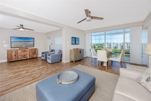 living room with wood-type flooring and ceiling fan