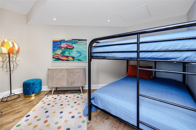 bedroom with hardwood / wood-style flooring and vaulted ceiling