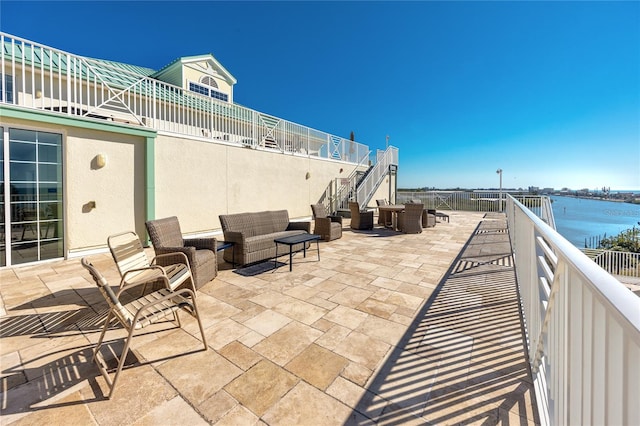 view of patio / terrace featuring outdoor lounge area and a water view