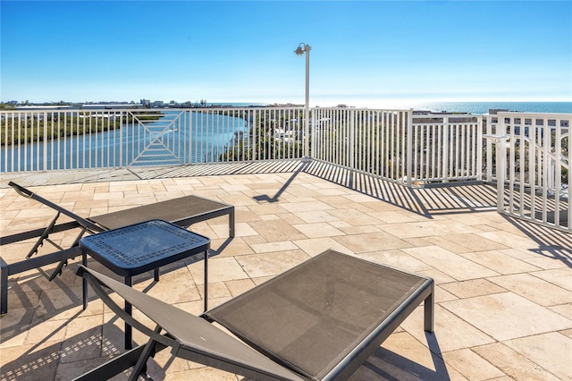 view of patio with a water view