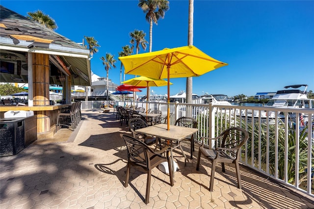 view of patio / terrace with a bar and a water view