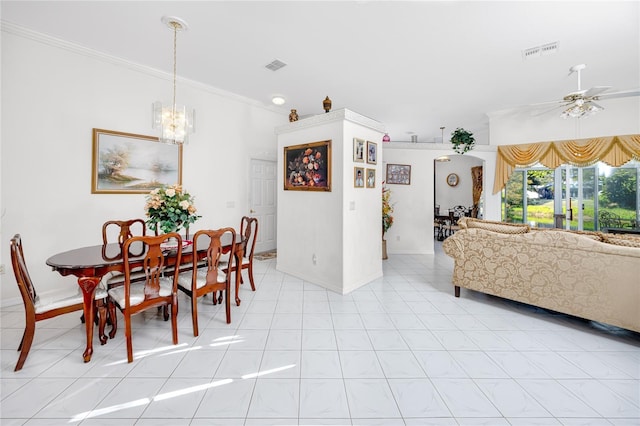 dining space featuring ceiling fan with notable chandelier and crown molding