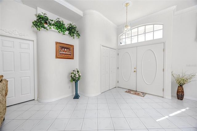 entrance foyer with crown molding and a notable chandelier