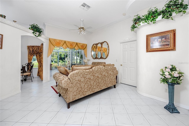 living room with crown molding, ceiling fan, and light tile patterned floors