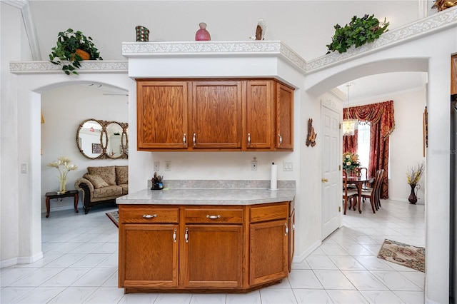 kitchen with light tile patterned flooring, a chandelier, and ornamental molding