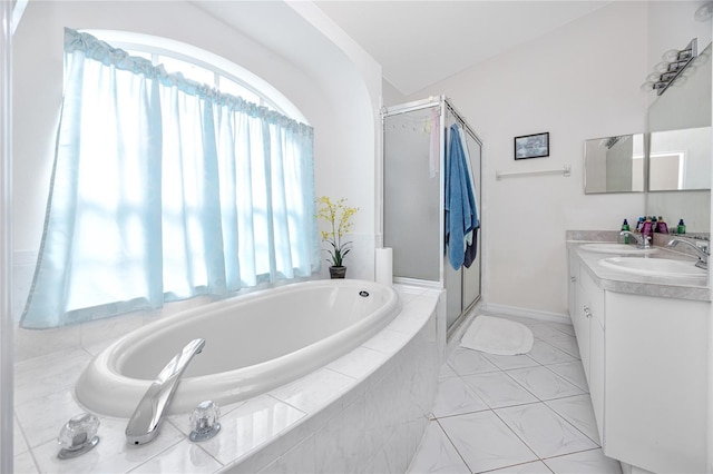 bathroom with tile patterned floors, vanity, independent shower and bath, and vaulted ceiling