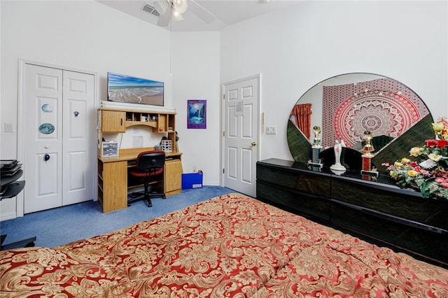 bedroom featuring carpet flooring, ceiling fan, and a high ceiling