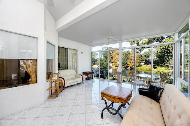 sunroom / solarium featuring ceiling fan and a water view