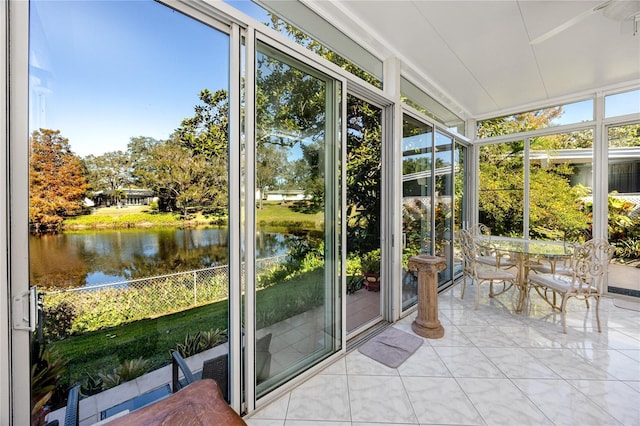 unfurnished sunroom with a water view