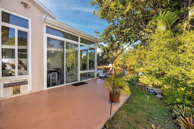 view of patio / terrace featuring a sunroom