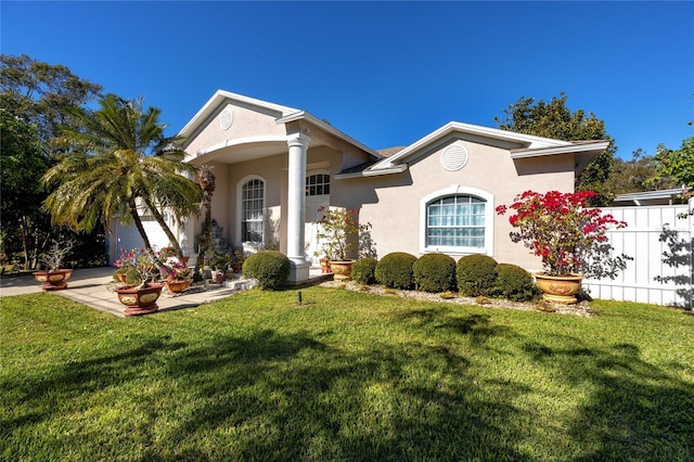 view of front of home with a front yard and a garage