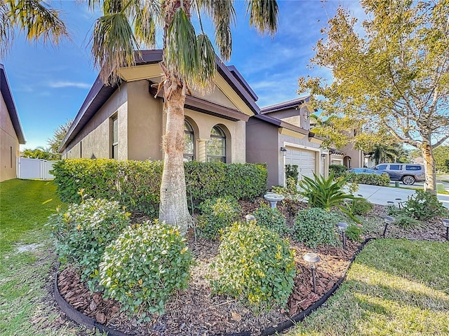 view of front of property featuring a garage and a front yard