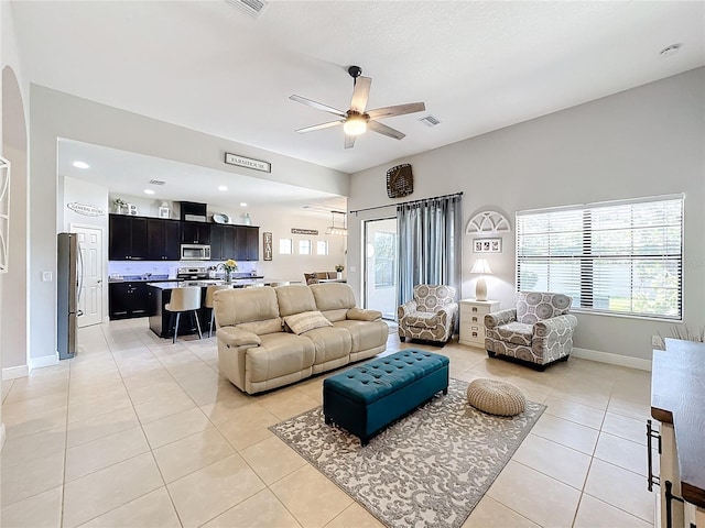 living room with ceiling fan and light tile patterned flooring