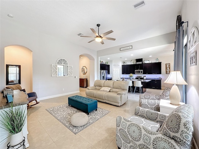 living room featuring ceiling fan and light tile patterned flooring