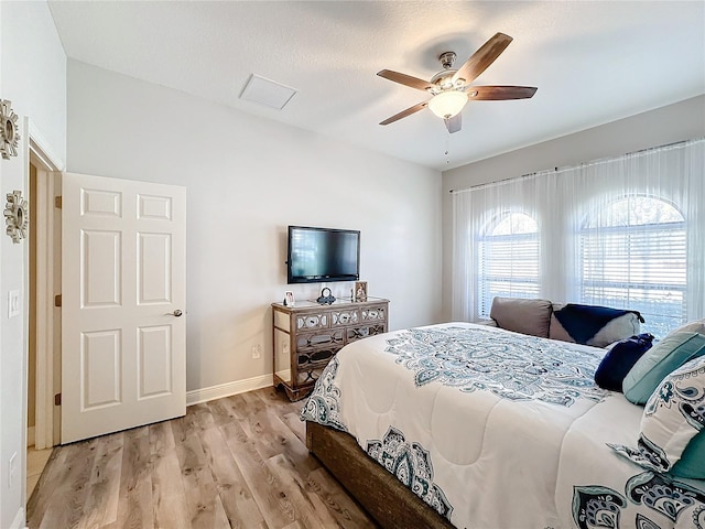 bedroom featuring a textured ceiling, light hardwood / wood-style flooring, and ceiling fan