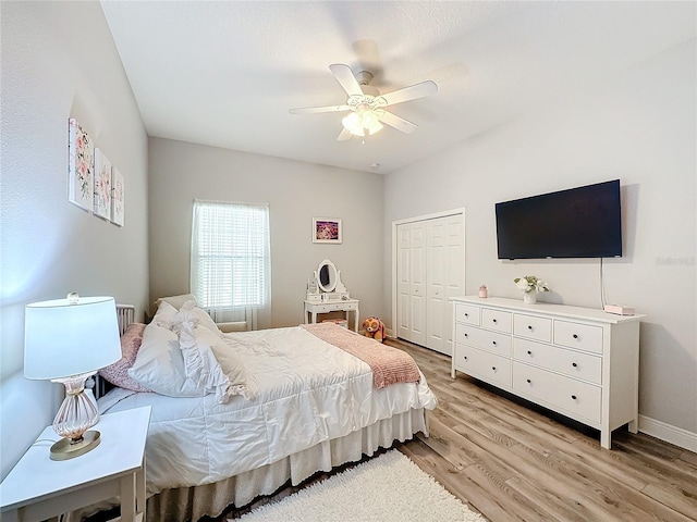 bedroom with light wood-type flooring, a closet, and ceiling fan