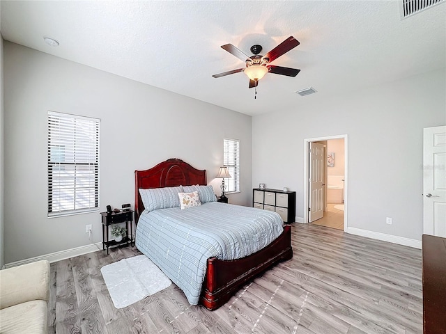 bedroom with connected bathroom, ceiling fan, a textured ceiling, and light wood-type flooring