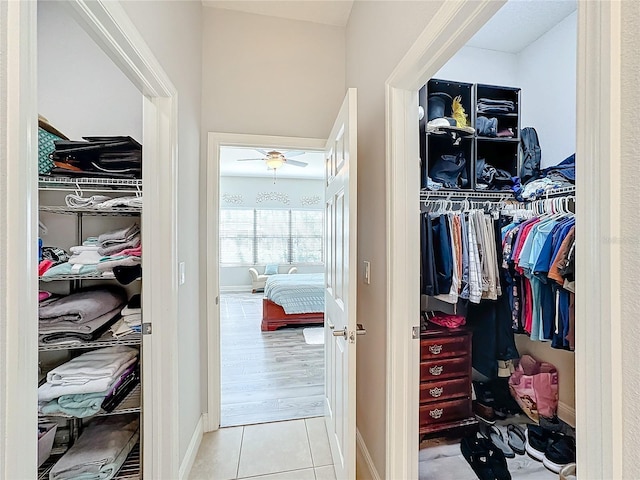 spacious closet featuring light wood-type flooring and ceiling fan