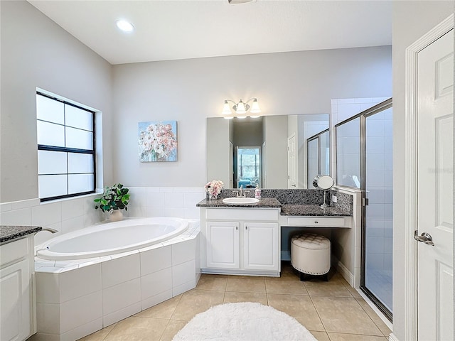 bathroom with tile patterned flooring, shower with separate bathtub, and vanity