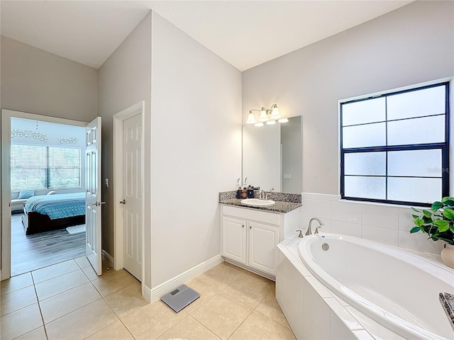 bathroom with vanity, tiled bath, and tile patterned floors