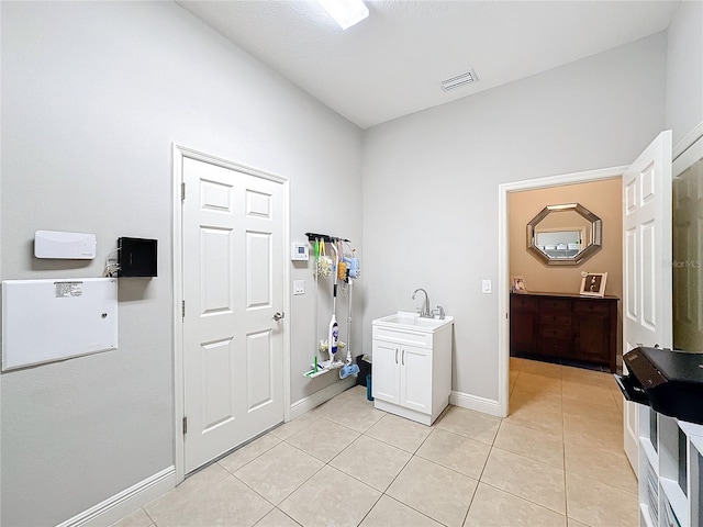 washroom with light tile patterned flooring and sink