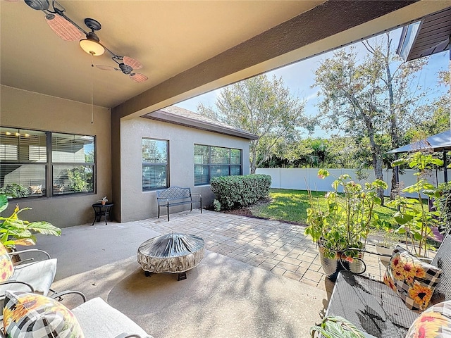 view of patio featuring a fire pit and ceiling fan