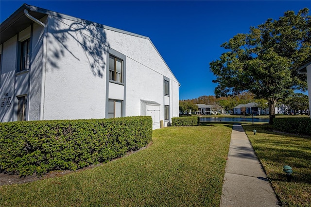 view of home's exterior with a yard