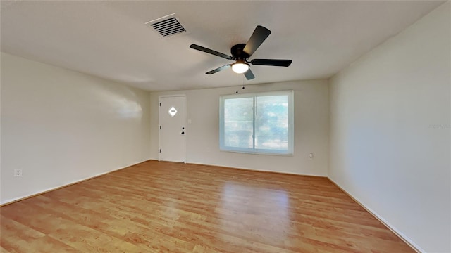 empty room with ceiling fan and light wood-type flooring