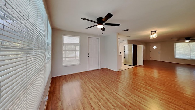 unfurnished living room with ceiling fan and light wood-type flooring