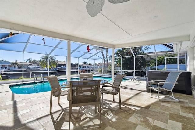 view of pool with a lanai, a patio area, and a hot tub