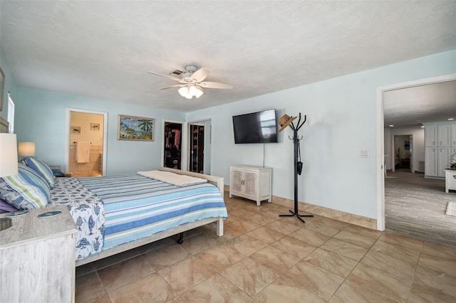 bedroom with connected bathroom, ceiling fan, a spacious closet, hardwood / wood-style floors, and a closet