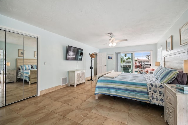 bedroom featuring a textured ceiling, a closet, and ceiling fan