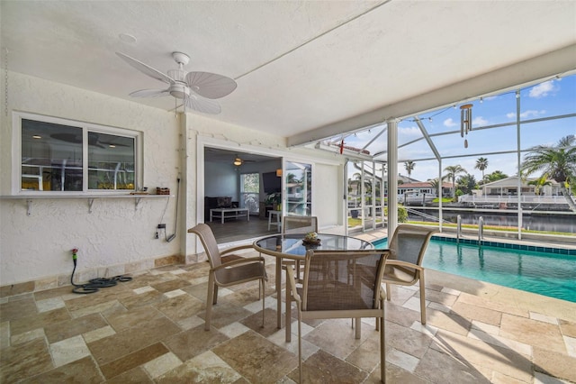 view of patio featuring ceiling fan and a lanai