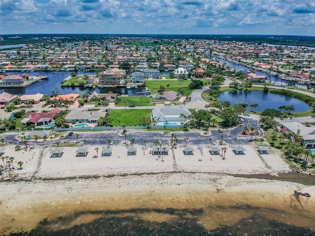 bird's eye view featuring a water view and a beach view