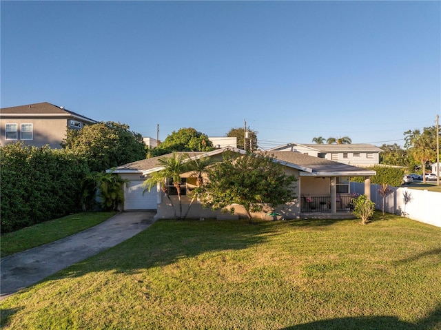 view of front of home with a front yard and a garage