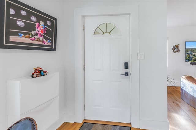 entryway featuring crown molding and hardwood / wood-style flooring