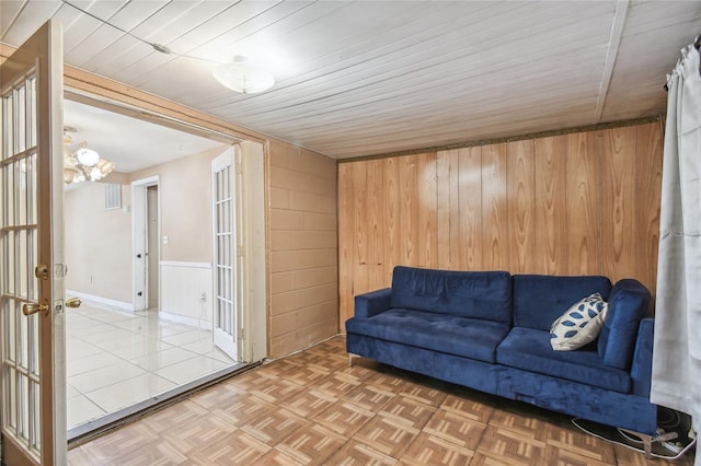 interior space with parquet floors and wood walls